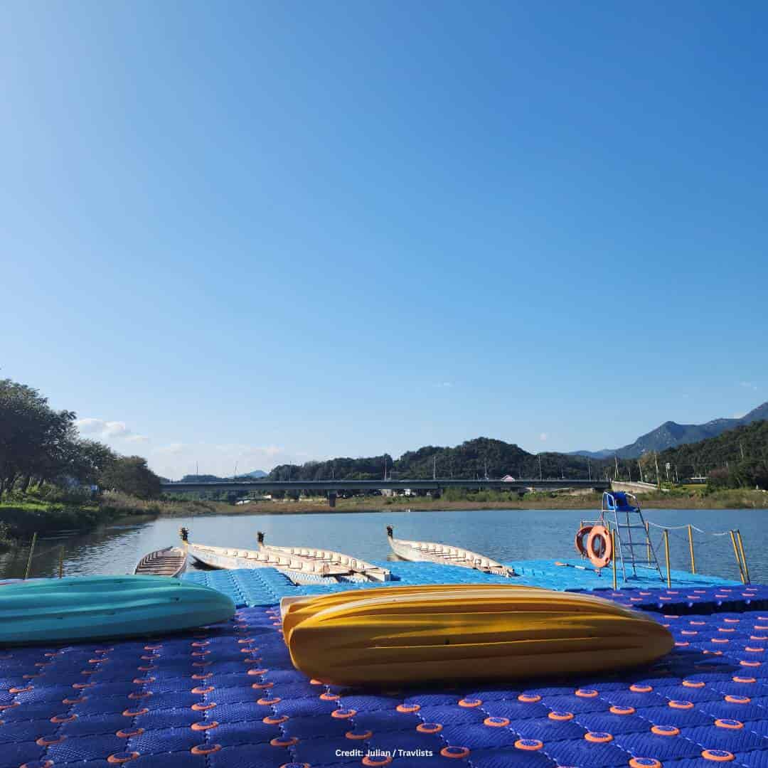 South Korea travel guide: river dock with traditional boats and mountain views